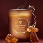 Aromatica Velvet Amber candle with amber crystals on a dark background