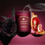 Aromatica candle with a black rose and pomegranate on a dark background