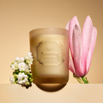 Candle with floral design on a beige background