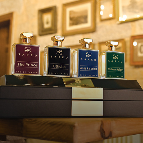 Collection of Sared perfume bottles on a wooden table with a blurred background